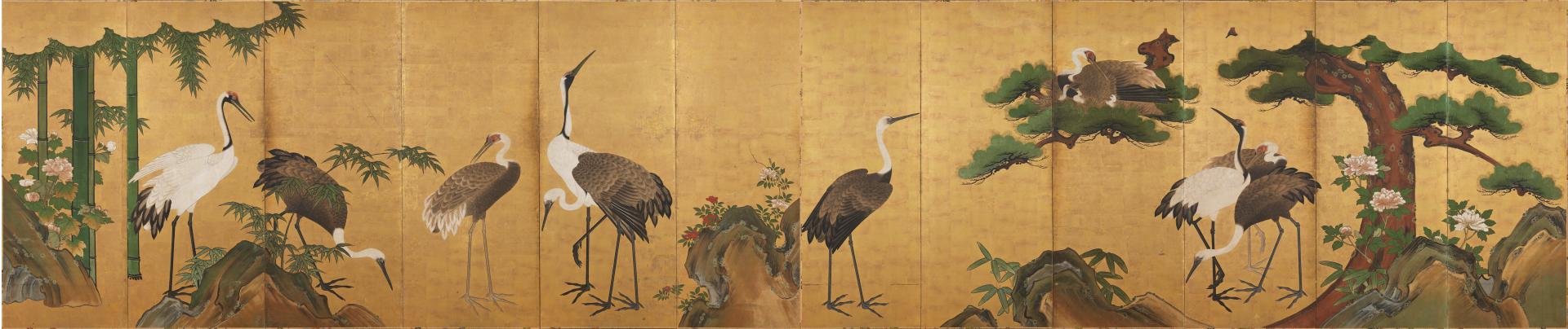 Long, horizontal painting made of twelve vertical panels, depicting cranes with brown and white feathers standing in different positions, with a pine tree growing on the right side and thick vertical stalks of green bamboo on the left. Rocky outcroppings of brown and green along the lower edge.
